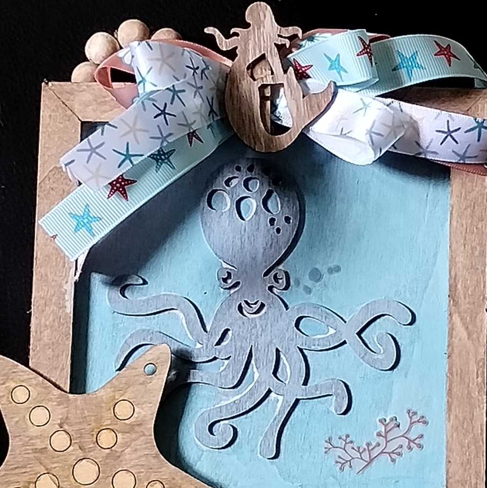 Octopus wall art with starfish ribbon and a mermaid ornament